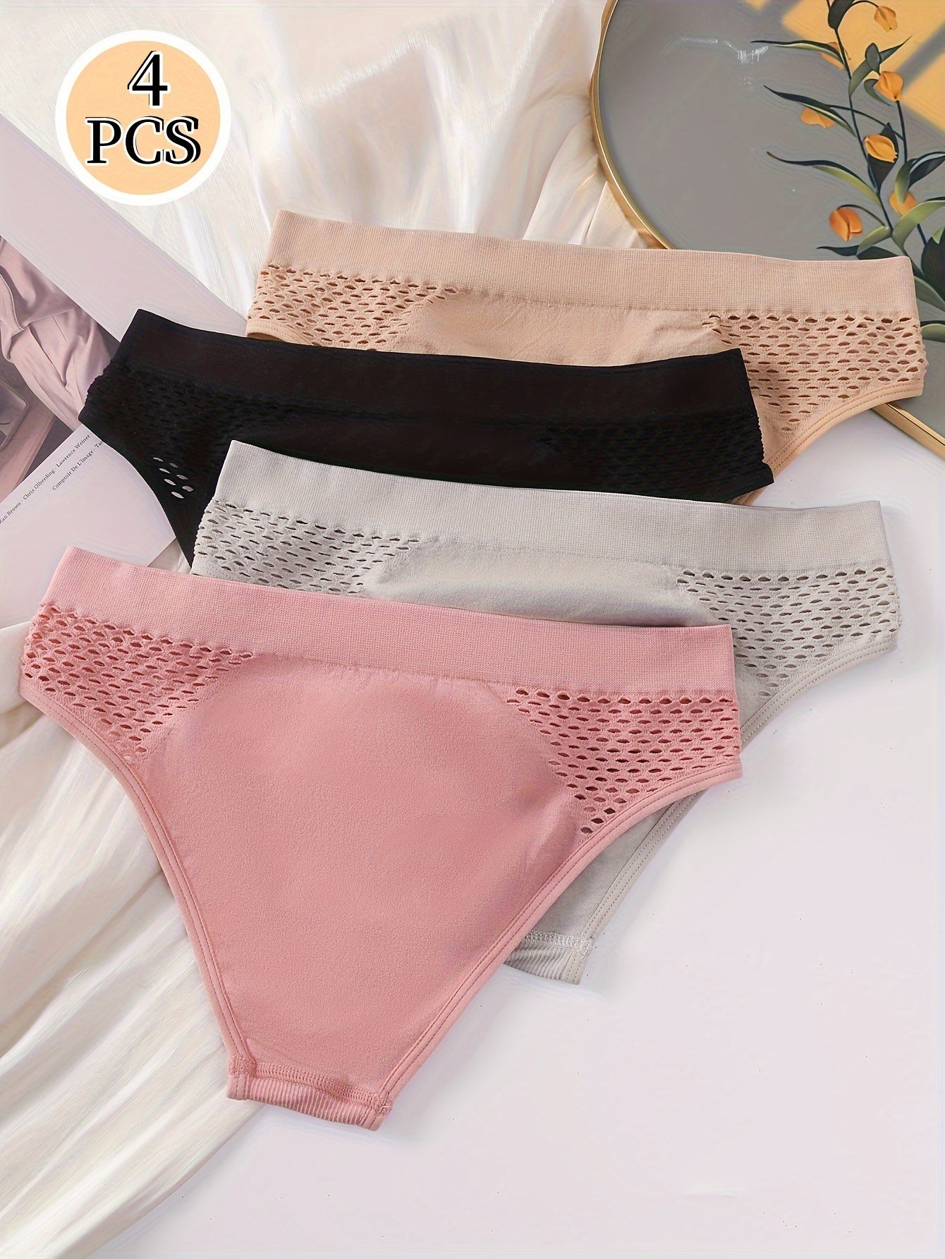 Four-pack of low-rise briefs for women, with hollow-out design and medium support. Made from a blend of 90% Polyamide and 10% Elastane knit fabric, in a solid color. Lightweight at 200gsm