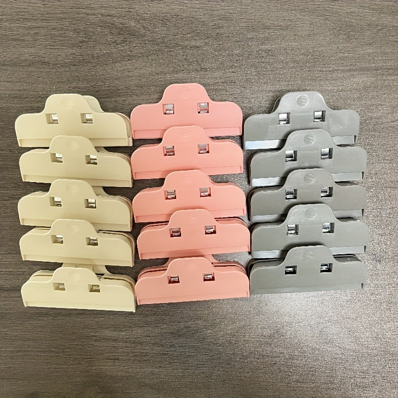 Set of 5 ABS Plastic Bag Clips in various colors for large, durable sealing in the kitchen. Keep snacks fresh with these beige, pink, light gray, and dark blue/black clips.