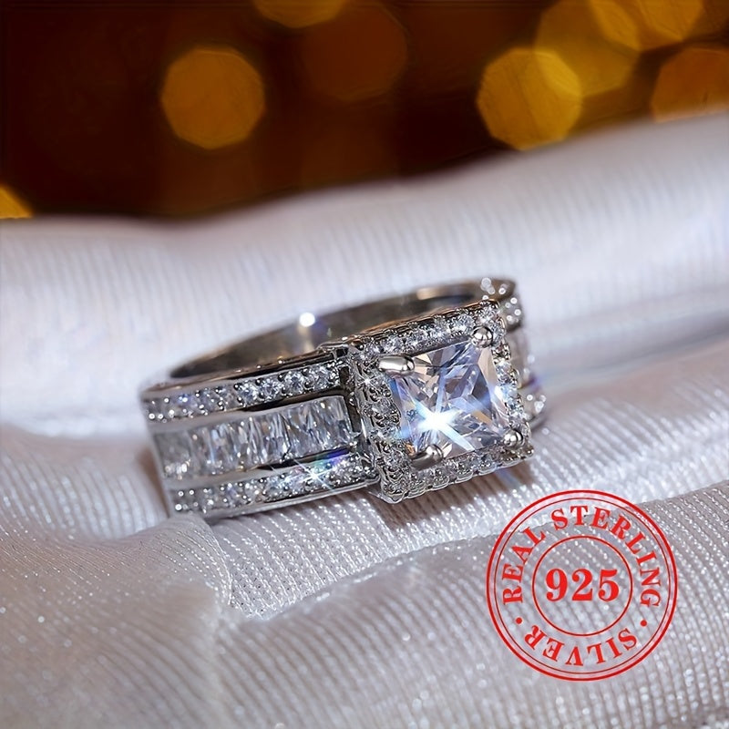 A stunning ladies' engagement wedding ring with a sparkling square cut zirconia set in 7.7 grams of S925 sterling silver. This elegant sterling silver jewelry piece is a fashionable accessory for any special occasion.