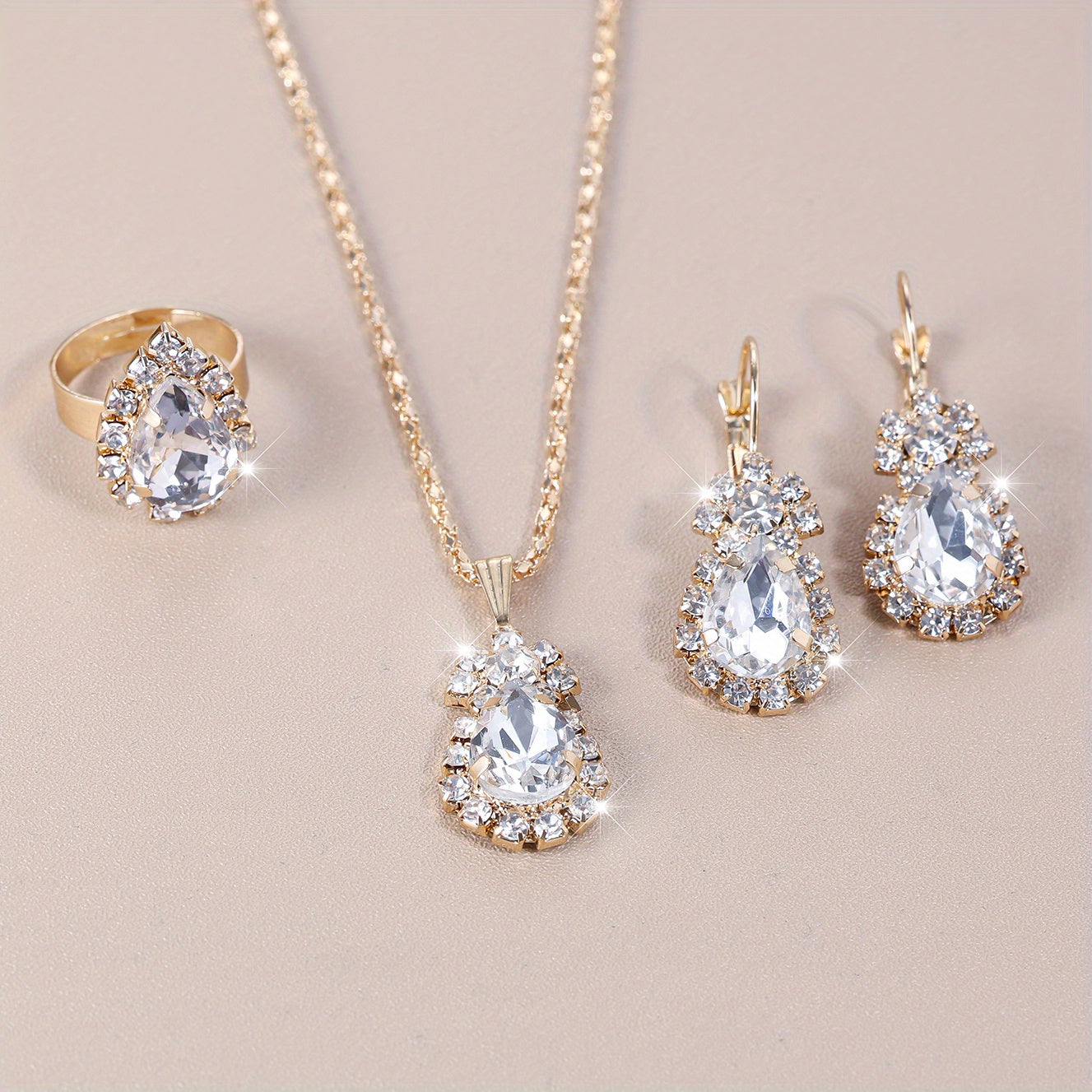 Complete your look with this elegant jewelry set featuring 4 pieces - earrings, necklace, and ring. Made with 18k gold plating and inlaid with shimmering zirconia in multiple colors to suit your style. Perfect for daily wear or adding a touch of glamour