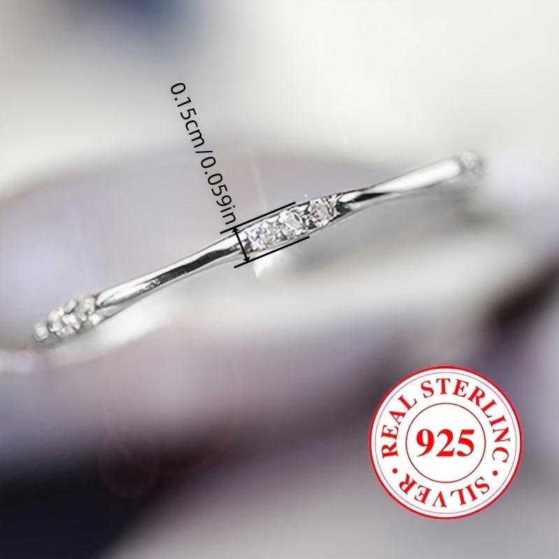 A sleek ring using only 1 gram of 925 sterling silver, embellished with shimmering zirconia, ideal for everyday wear or special occasions such as weddings.