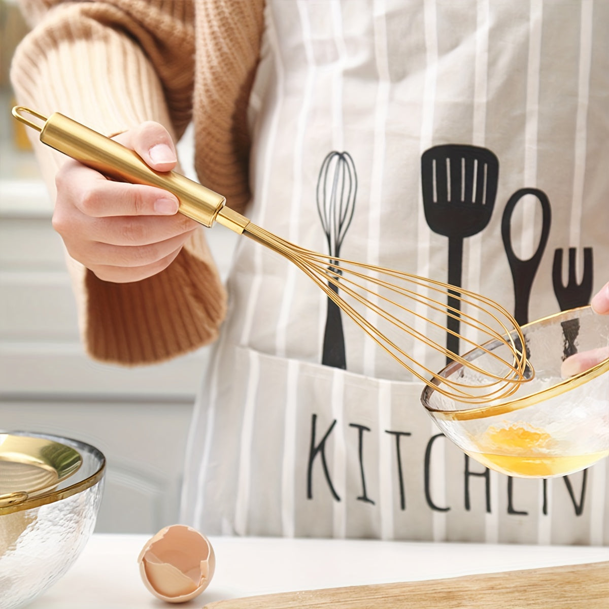 Golden Stainless Steel Egg Whisk is a versatile baking tool that is perfect for cooking in nonstick cookware. This heat-resistant kitchen whisk can be used for mixing, whirling, foaming, and stirring food.