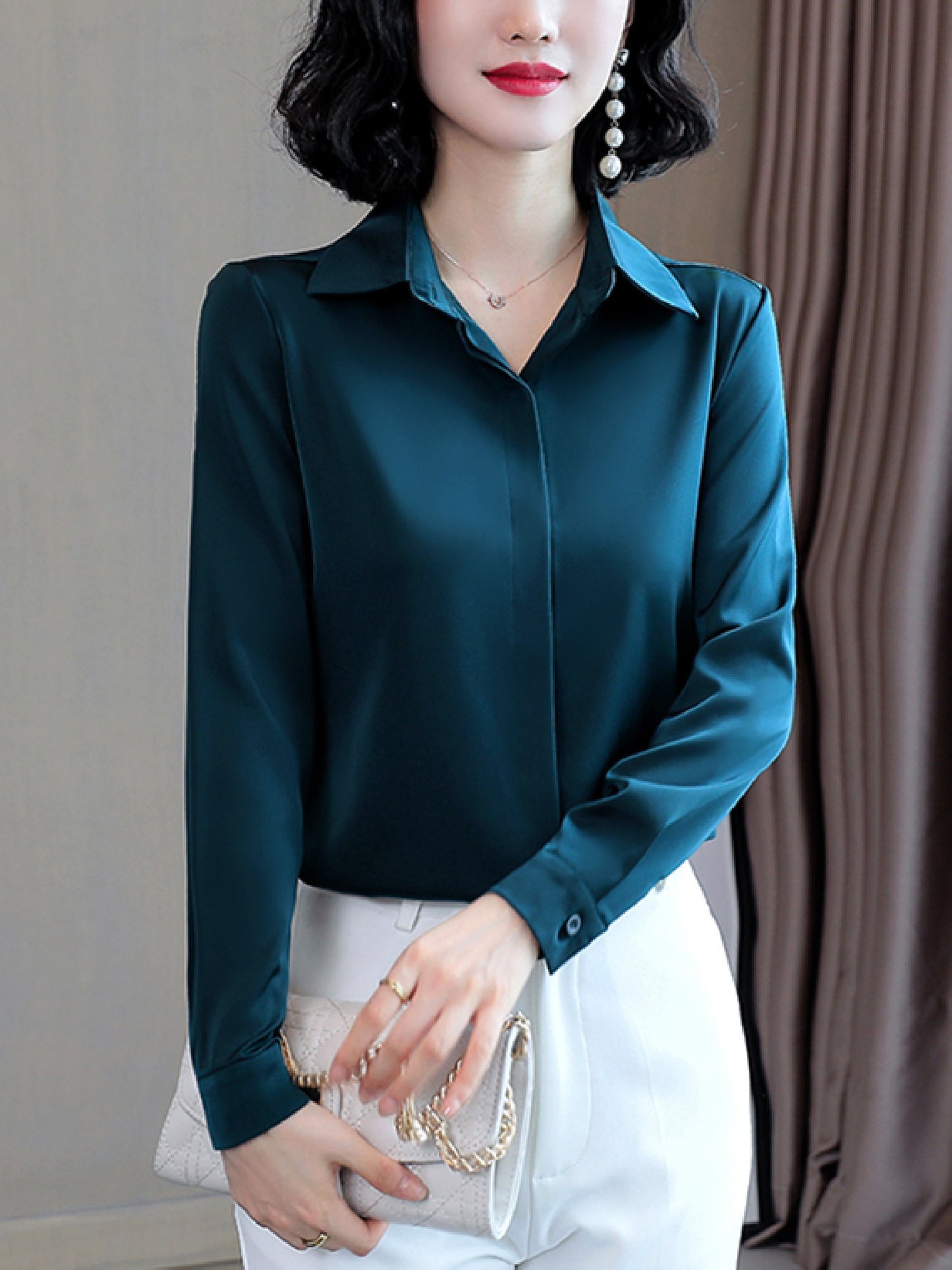 Long sleeve satin shirt with solid color, collared button-up design for women. Machine washable and perfect for spring/fall. Ideal for sophisticated adults with luxurious style.