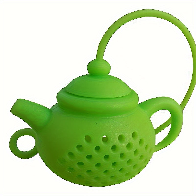 Reusable teapot-shaped tea infuser made of silicone for loose leaf tea, ideal for kitchen and dining use, small in size suitable for making tea.