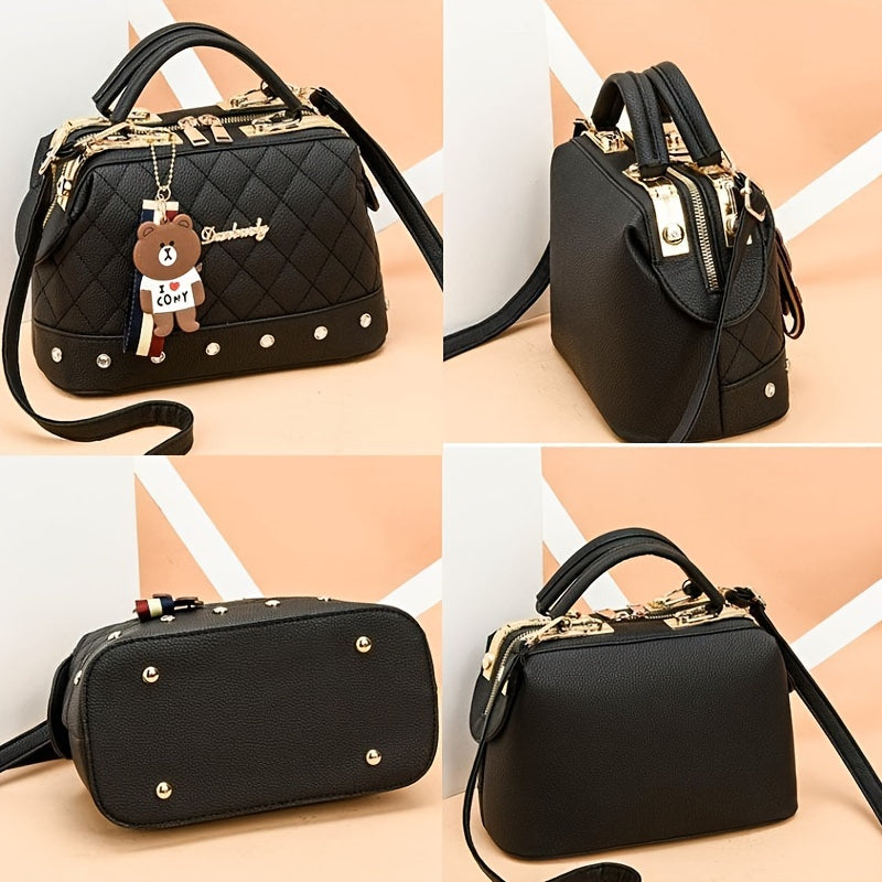 Stylish black shoulder bag for women with cute bear charm, detachable strap, zip closure, and quilted texture - ideal for travel and shopping.