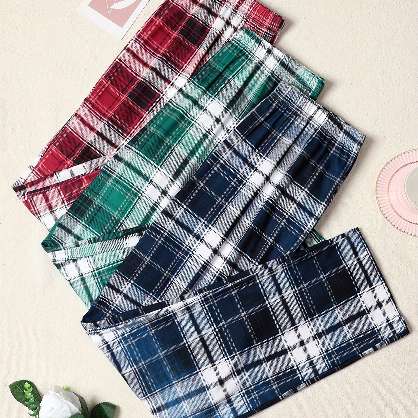 3-pack of men's plaid pajama pants with comfortable medium stretch knit fabric in assorted designs.