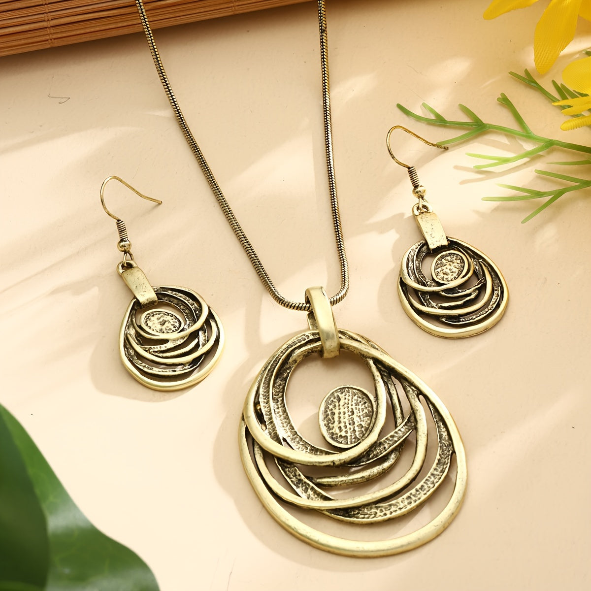 This set includes a pair of earrings and two necklaces made of zinc alloy in an ancient silvery color. The necklaces feature a multi-layer circular mosaic design with a retro bohemian style and a hollow center. This leisure jewelry set is perfect as a