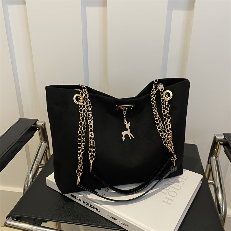 Stylish deer pendant women's tote bag with large capacity, golden-tone chain straps, black color, magnetic closure, versatile for everyday use.