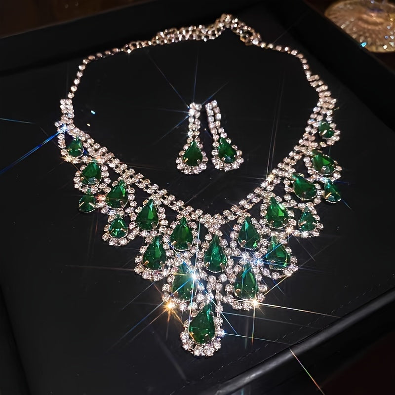 Elegantly designed in a vintage teardrop tassel style, this set features a luxurious green rhinestone necklace and matching earrings. Crafted with a copper base and plated in 18K gold, the earrings have 925 silver ear posts for a touch of sophistication.