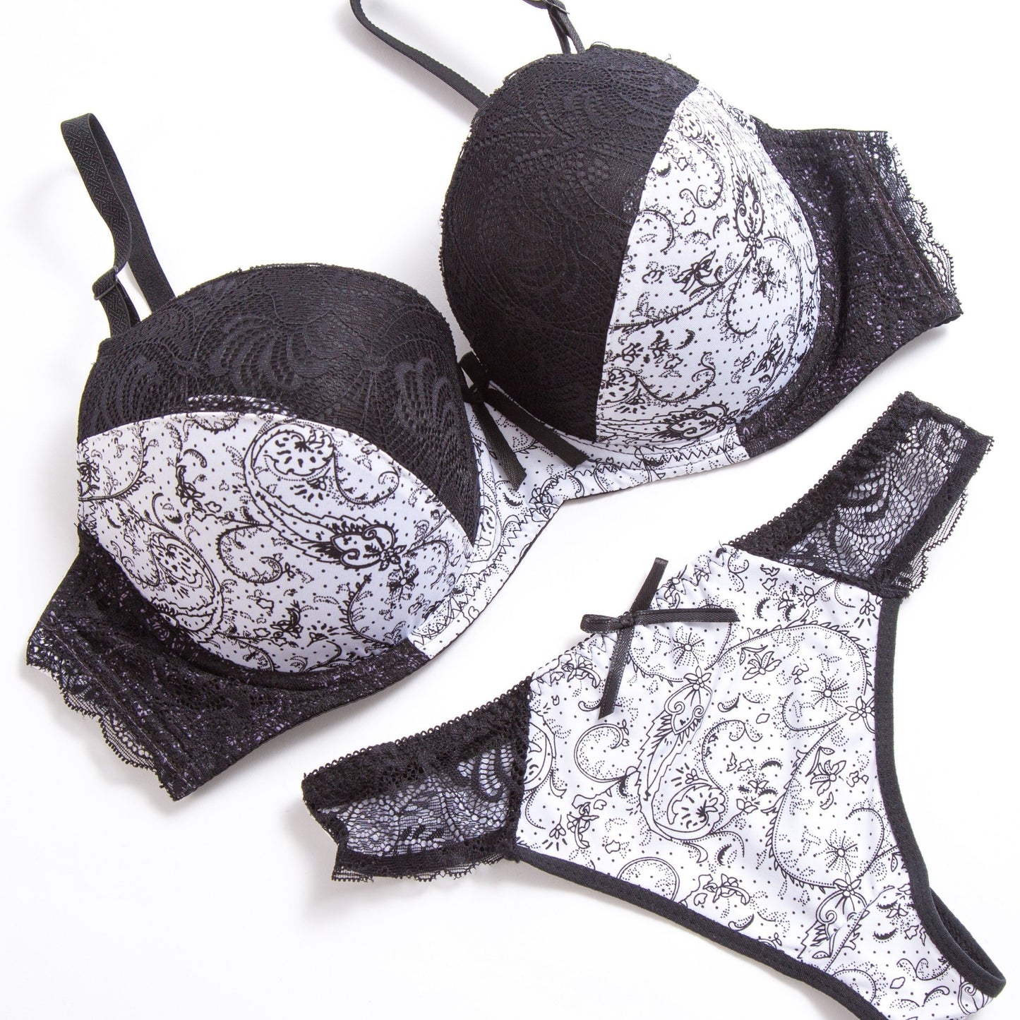 Sophisticated lace bra and panty set in beige and black floral print. Hand washable nylon blend for comfort and versatility. Perfect for casual wear or special occasions. Smooth texture