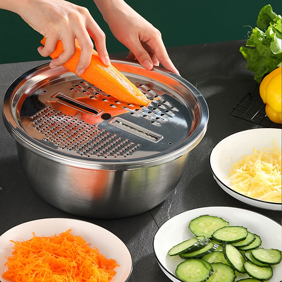 This stainless steel vegetable slicer and grater is compatible with containers measuring 26.01cm and 27.94cm. It is ideal for slicing and grating fruits and vegetables, making it a convenient and dishwasher-safe kitchen tool.