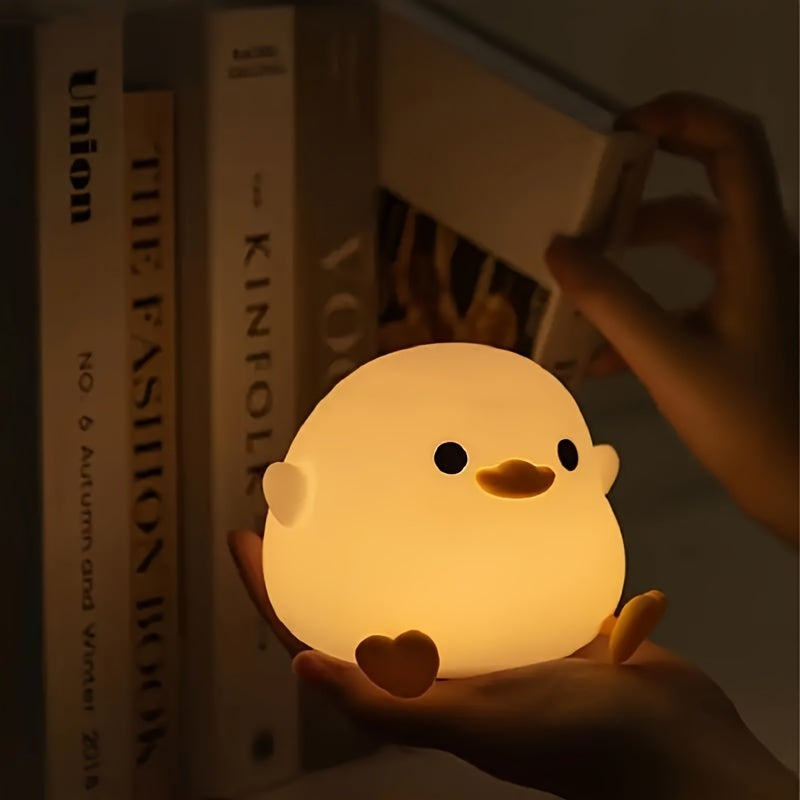 A whimsical Cute Duck-Shaped Table Lamp with a Geometric Pattern and White Matte Finish. This battery-powered lamp includes a switch, a plastic shade, and a G13 bulb base for ≤36V. Perfect for bedside reading or as a nursery night light, providing gentle