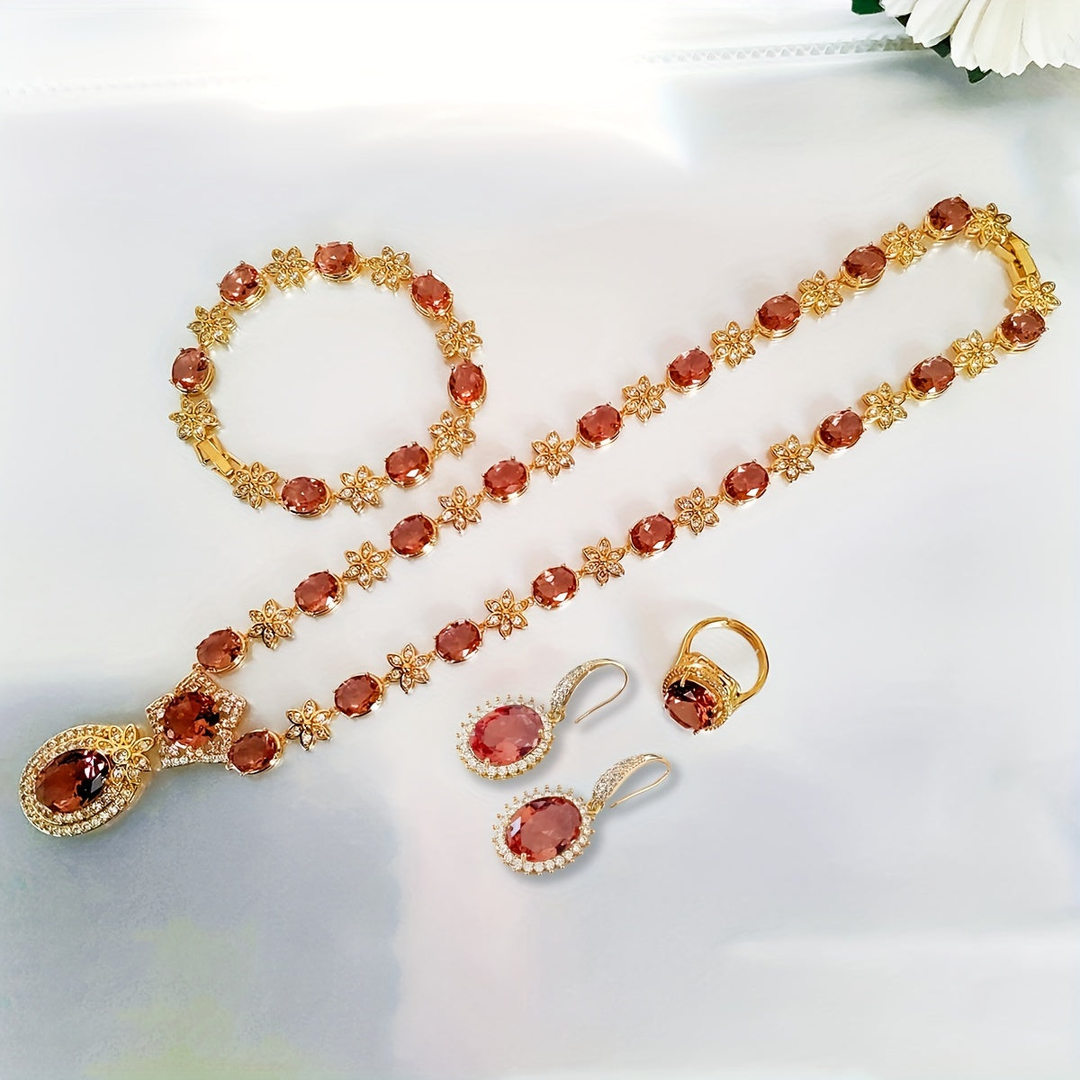 Introducing the MEETMAY Synthetic Color Changing Sultanite Diaspore Oval Sunflower Jewelry Set. This elegant copper-tone four-piece set includes a ring, earrings, bracelet, and necklace. The colors are customizable to adapt to different lighting