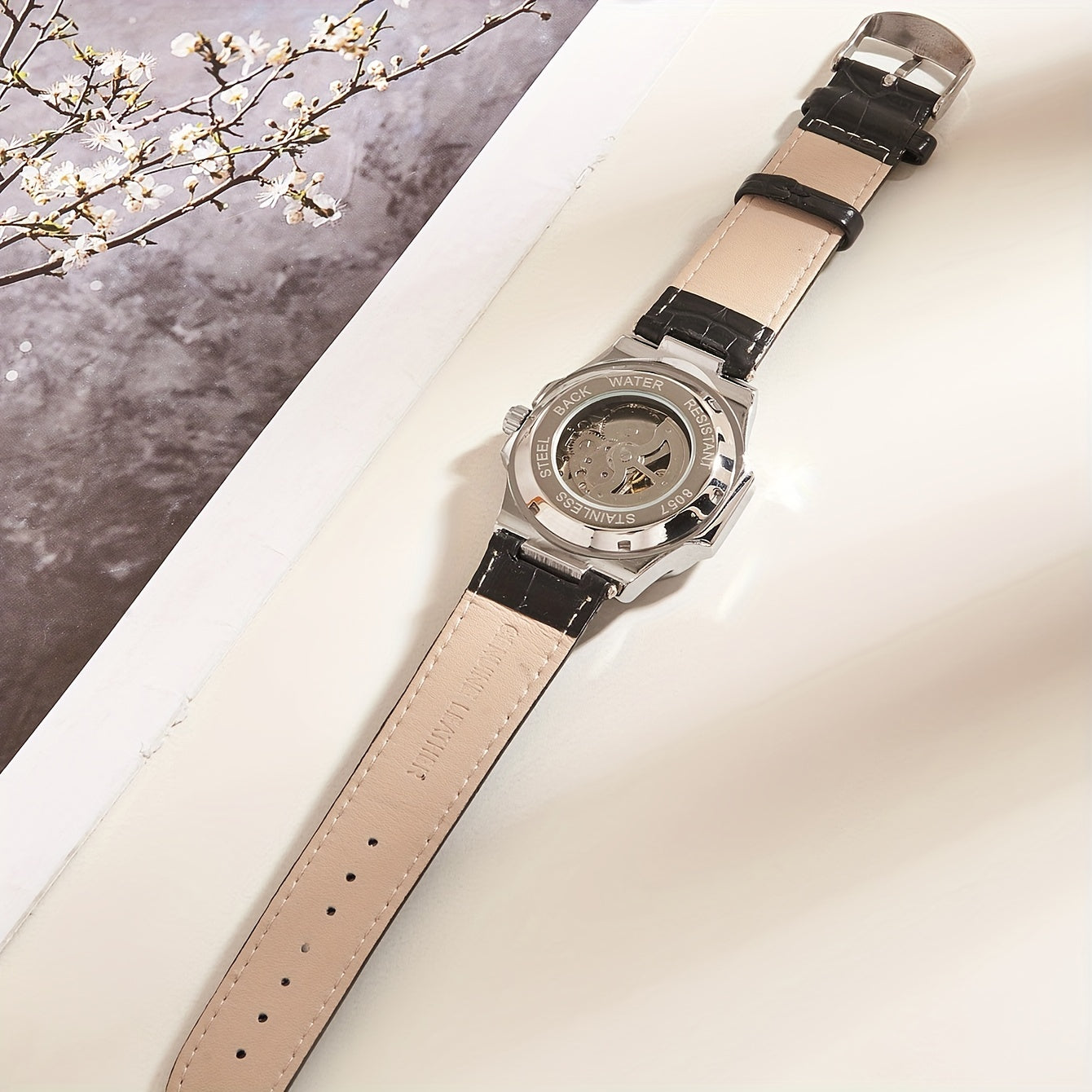 Model #8057P features a 4.1cm barrel-shaped faux leather strap, square dial, waterproof mechanical design suitable for both business and casual wear. It also includes a mineral glass face