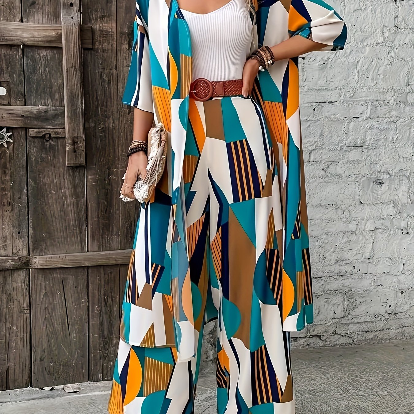 Stylish plus-size geometric print ensemble includes open front shirt, wide-leg pants made of elegant polyester. Perfect for fashion-forward ladies, machine washable.