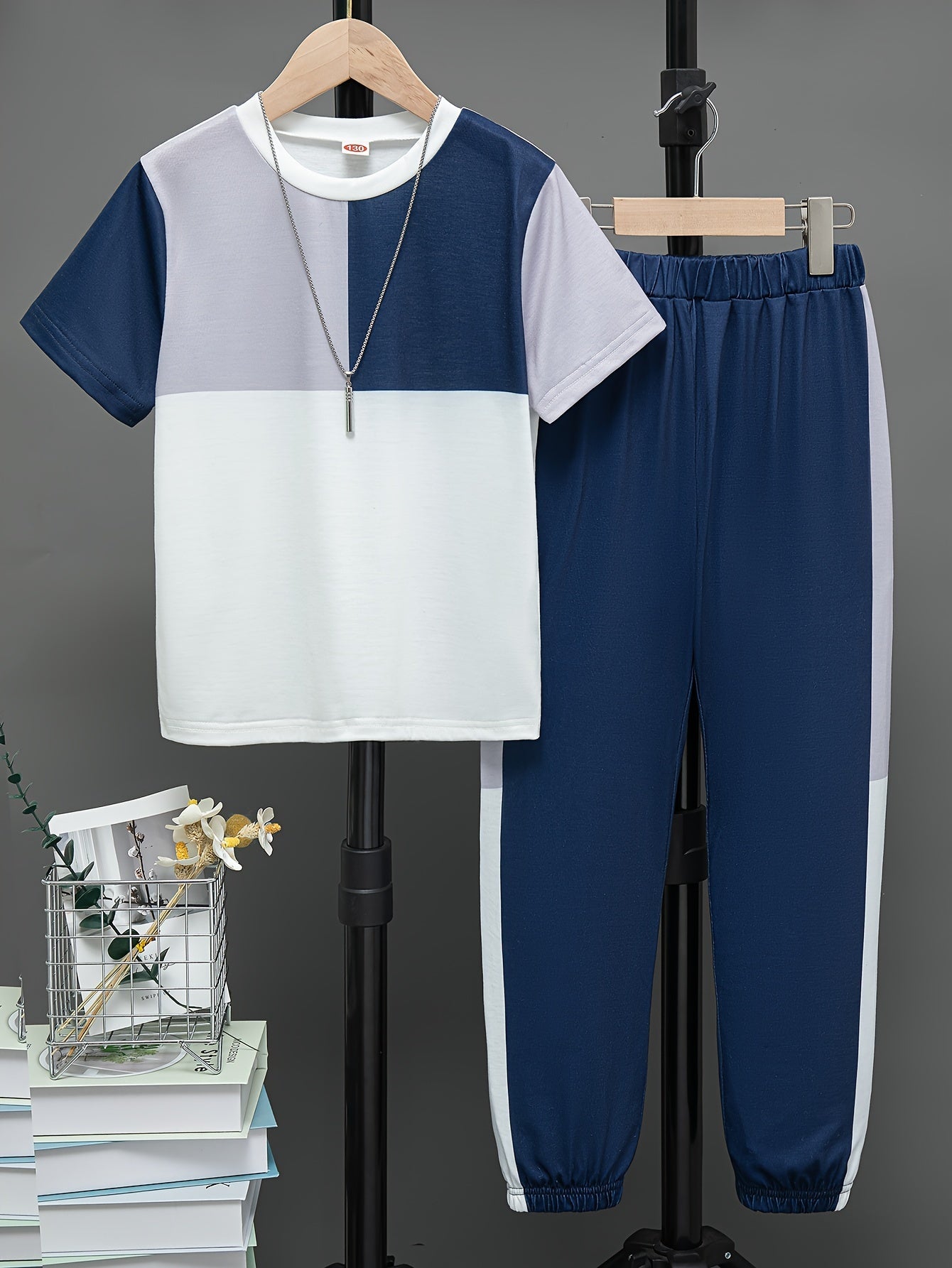 Boys' summer casual outfit: Round neck short sleeve top with contrast design and trousers set, ideal for outdoor activities.