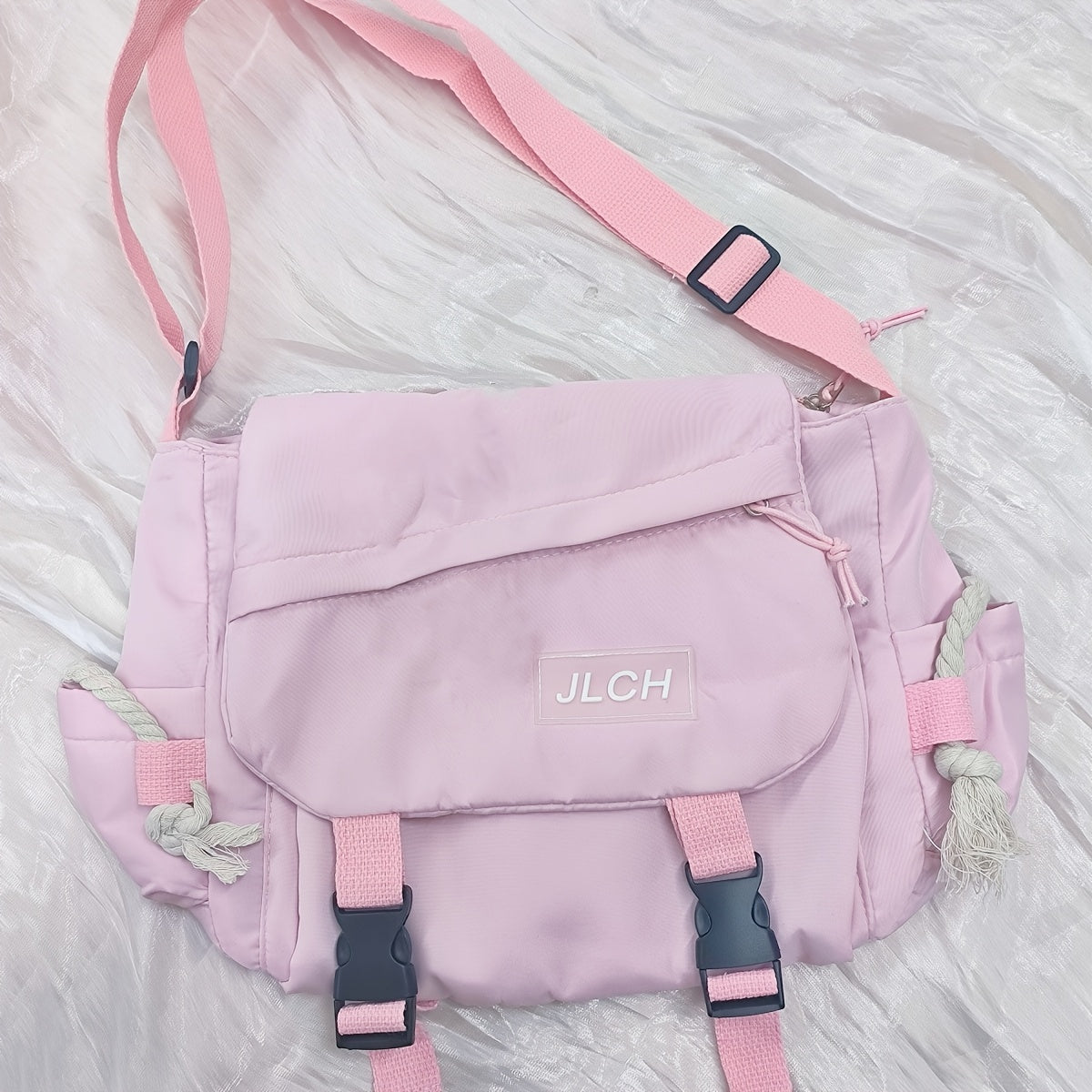 Adjustable unisex shoulder bag in white, pink, blue, or black, suitable for school, travel, and everyday use with a stylish and functional design.