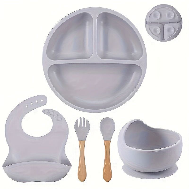 Set of 5 Baby Silicone Tableware including a fork and spoon with wooden handles, silicone bowl, divided plate, and waterproof bib. Conveniently washable and an essential addition to any household.