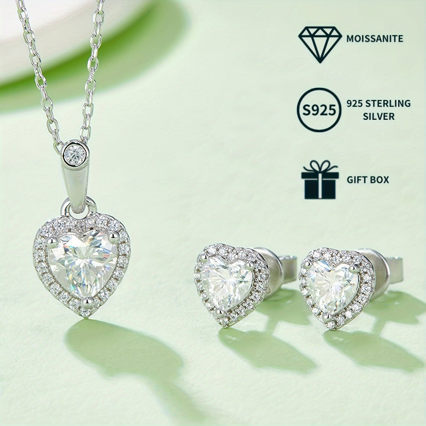 A set of elegant women's jewelry includes a pair of heart-shaped s925 silver earrings featuring 0.5ct*2 moissanite stones, a 1.0ct moissanite pendant necklace, and a matching necklace chain. The set weighs 2.88g for the necklace and 1.58g for the