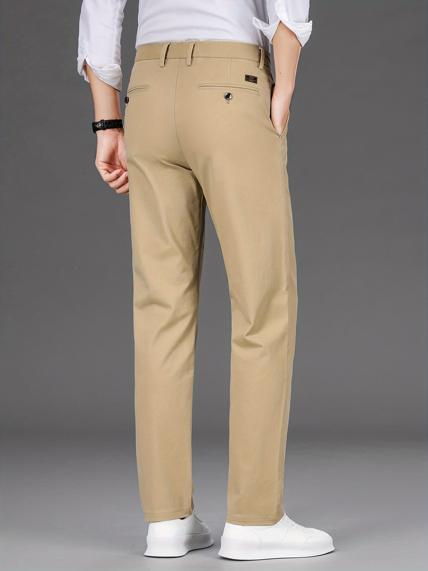 Men's slim-fit cotton blend trousers in solid color, suitable for business casual wear throughout the year. Features micro-elastic fabric, pockets, and regular length.