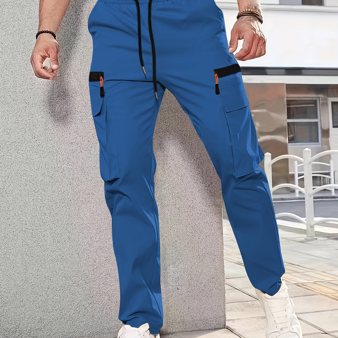 Men's casual cargo pants made of solid color polyester, feature a regular fit, multiple pockets, and straight-leg design for sports and leisure activities all year round.