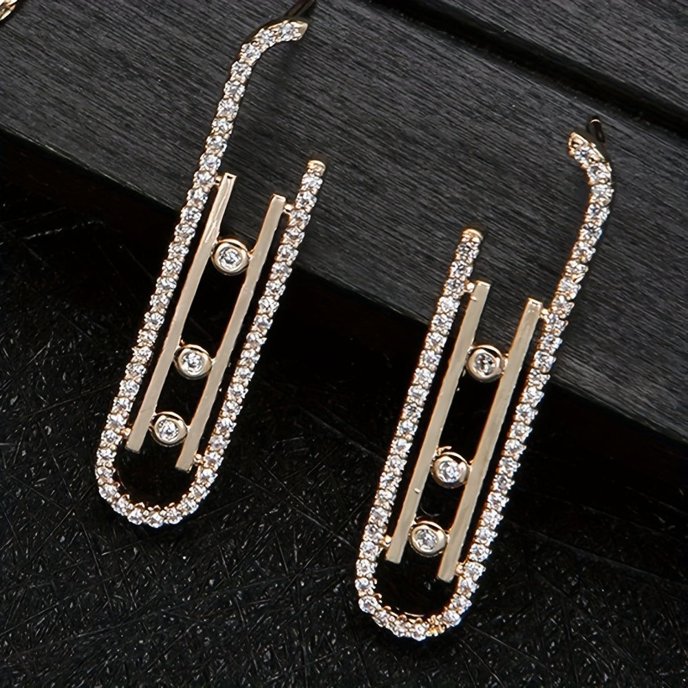 Set of extravagant European-inspired zirconia long earrings with copper spiral pins, paired with a matching ear jewelry necklace.