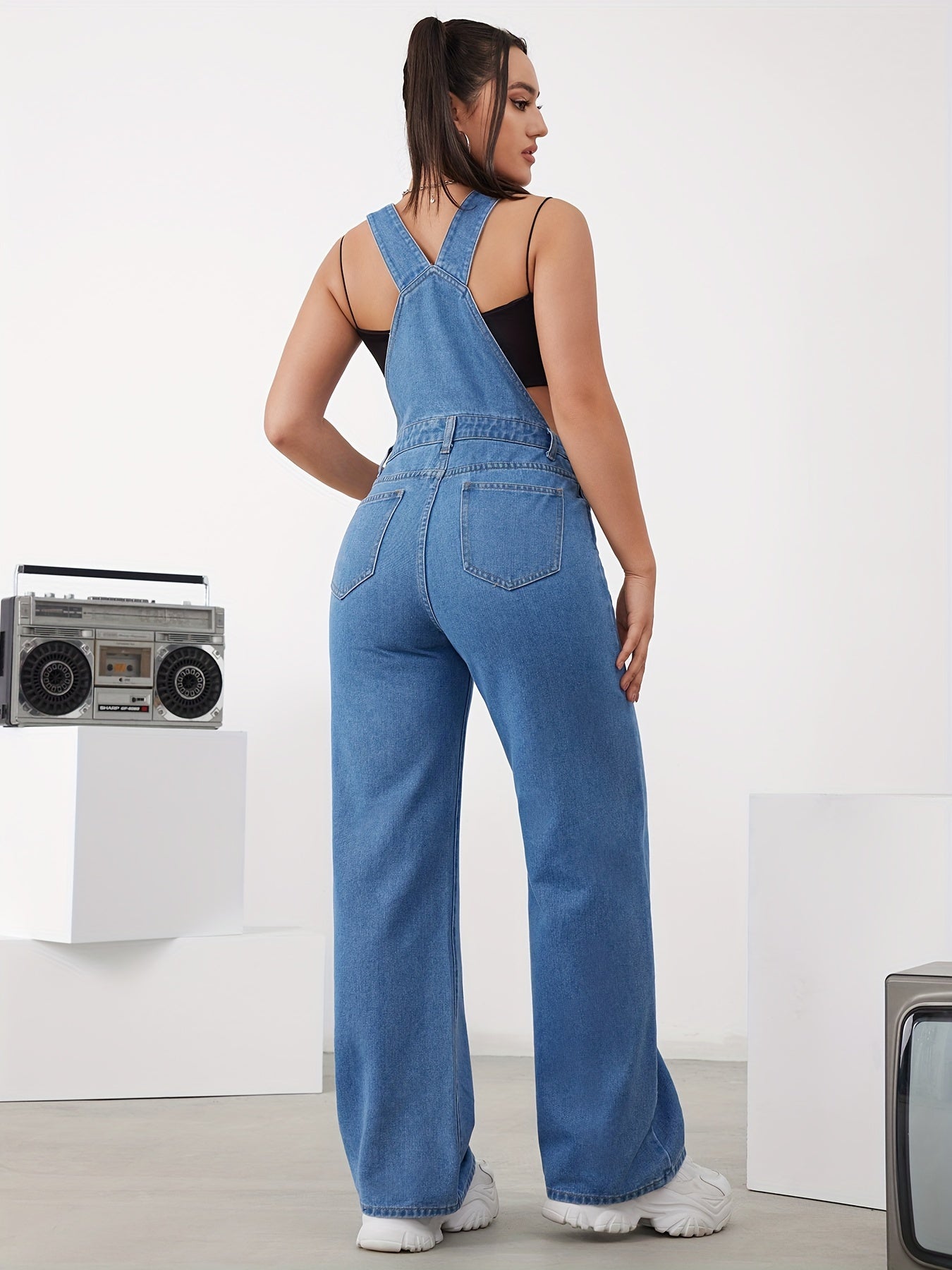 Women's adjustable denim overalls with wide-leg jeans, button detail, and machine washable.