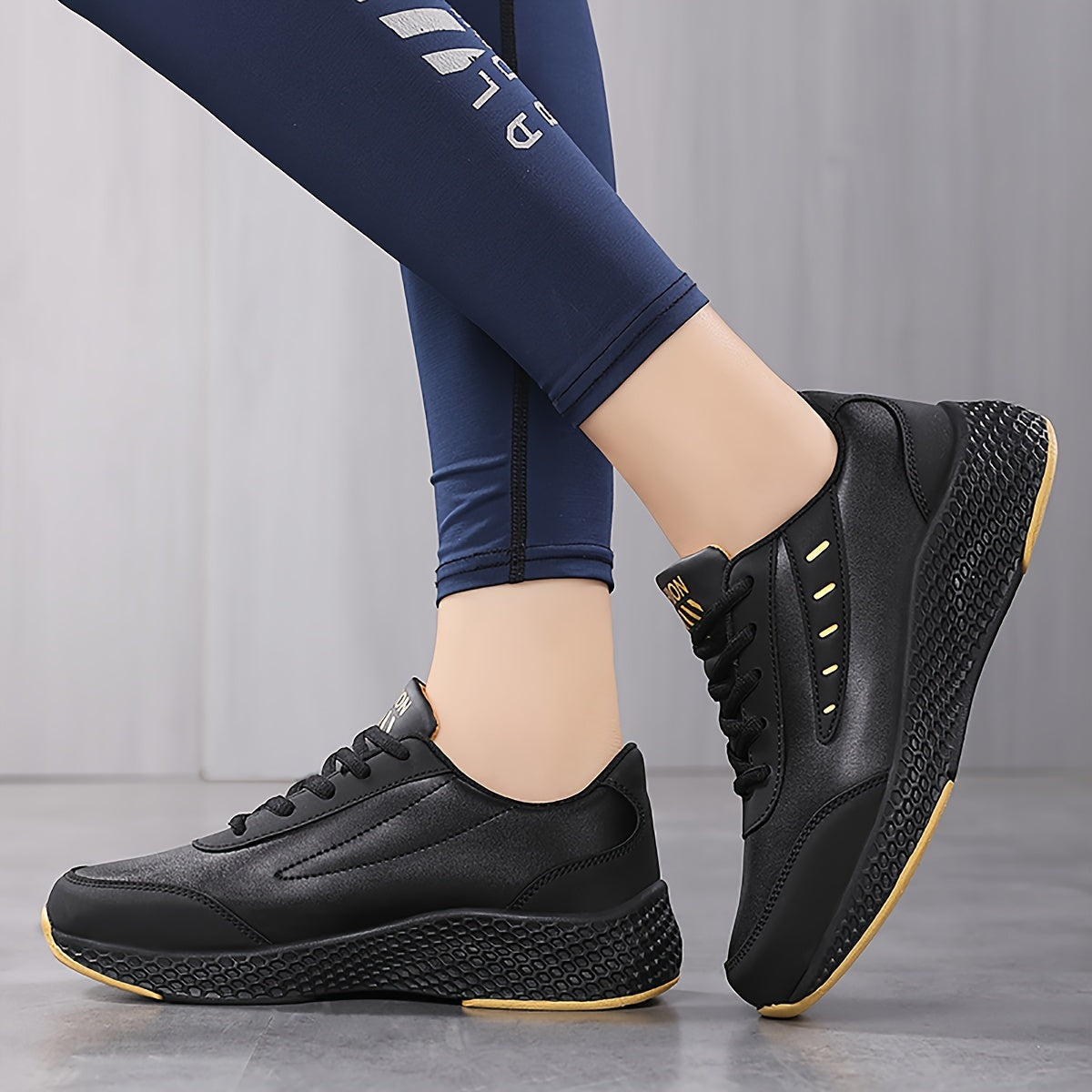 Black platform sneakers for women with lace-up design and comfortable fit, suitable for outdoor activities.