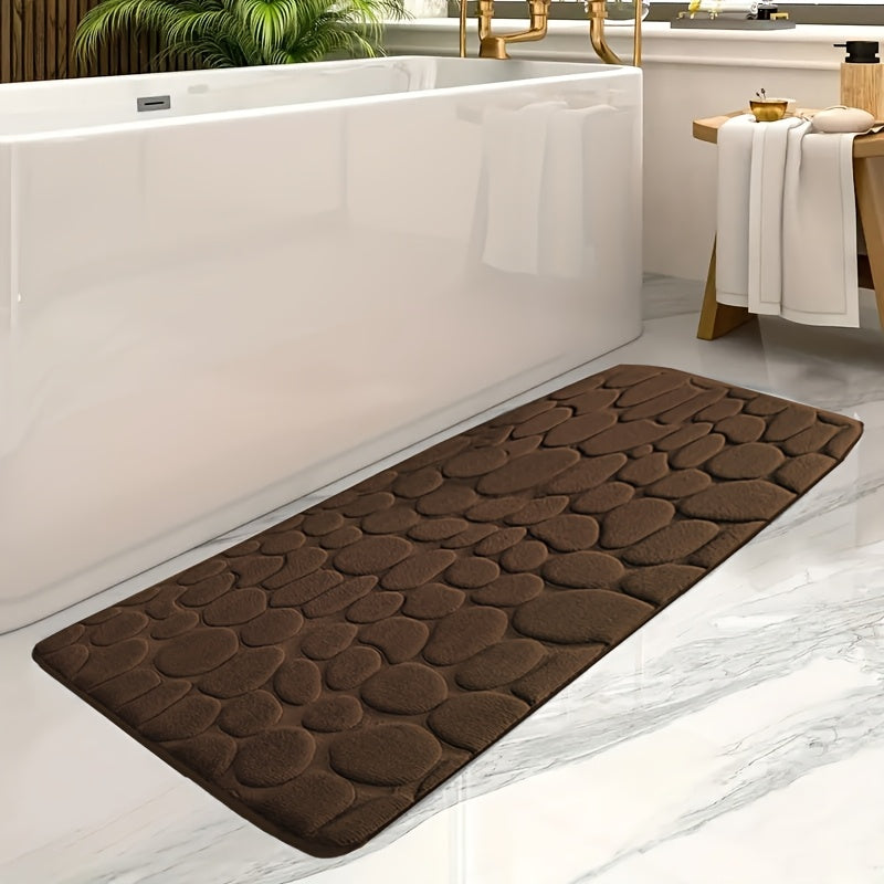 Soft coral fleece memory foam bath mat with geometric design, non-slip and absorbent. Machine washable polyester rug for bathroom and entryway decor.