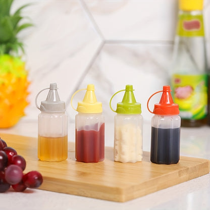 Set of 4 mini sauce bottles for condiments and spices, ideal for lunches, picnics, and kitchen use.