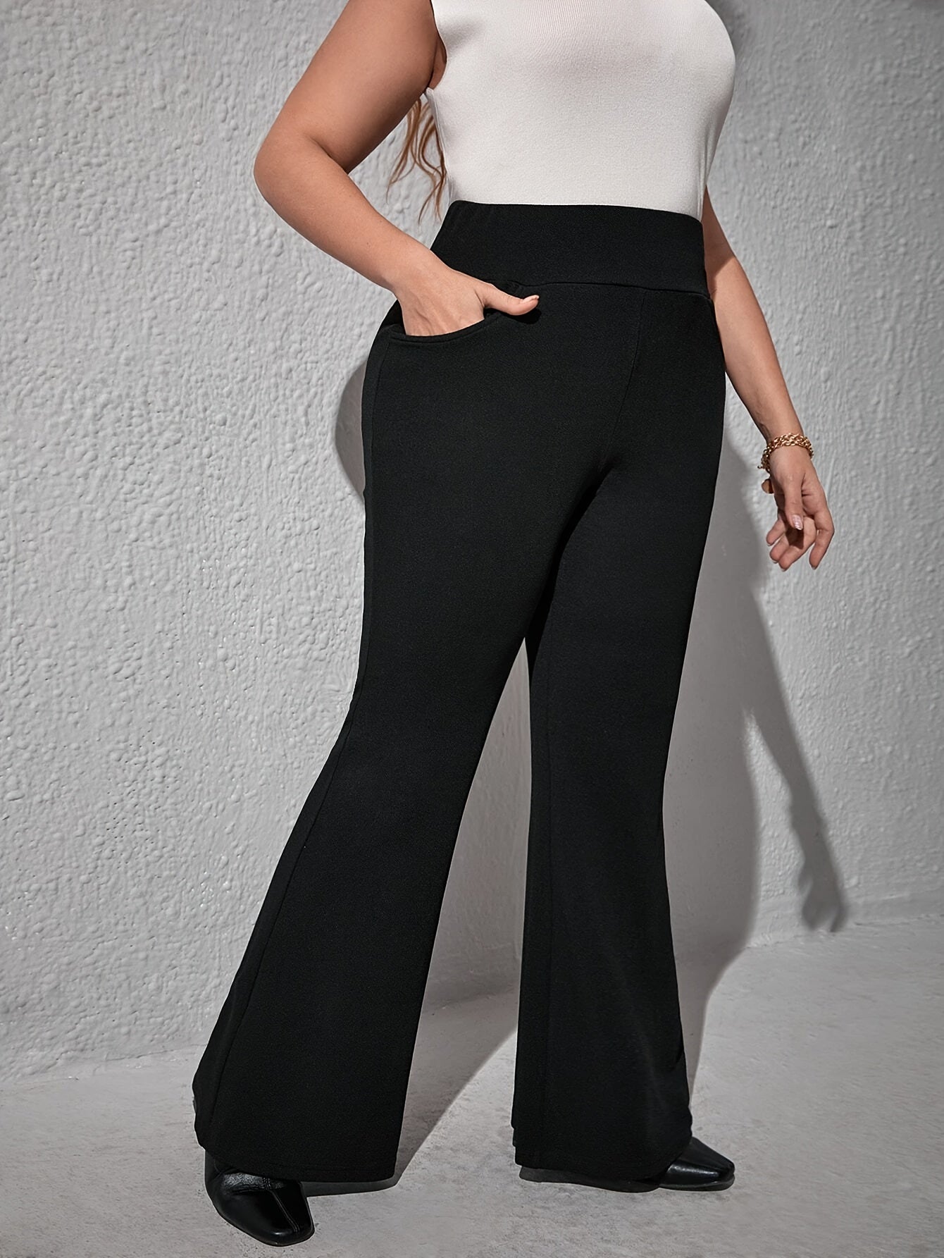 Elegant high-waist flare pants for plus size, with slant pockets, stretch knit, and machine washable - ideal for spring and fall.