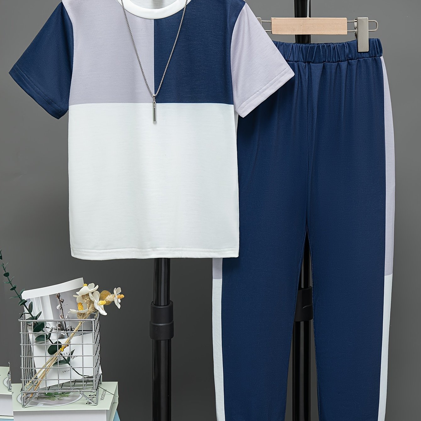 Boys' summer casual outfit: Round neck short sleeve top with contrast design and trousers set, ideal for outdoor activities.