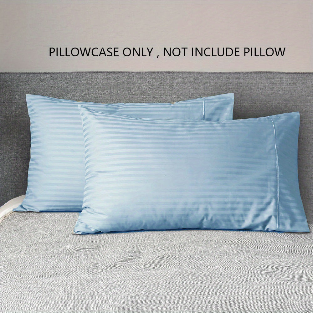 A pair of striped pillowcases made from soft, breathable woven polyester. These pillowcases are machine washable and have a sanded finish for added comfort. They do not include a pillow insert and are made from non-printed lightweight fabric with a 90gsm