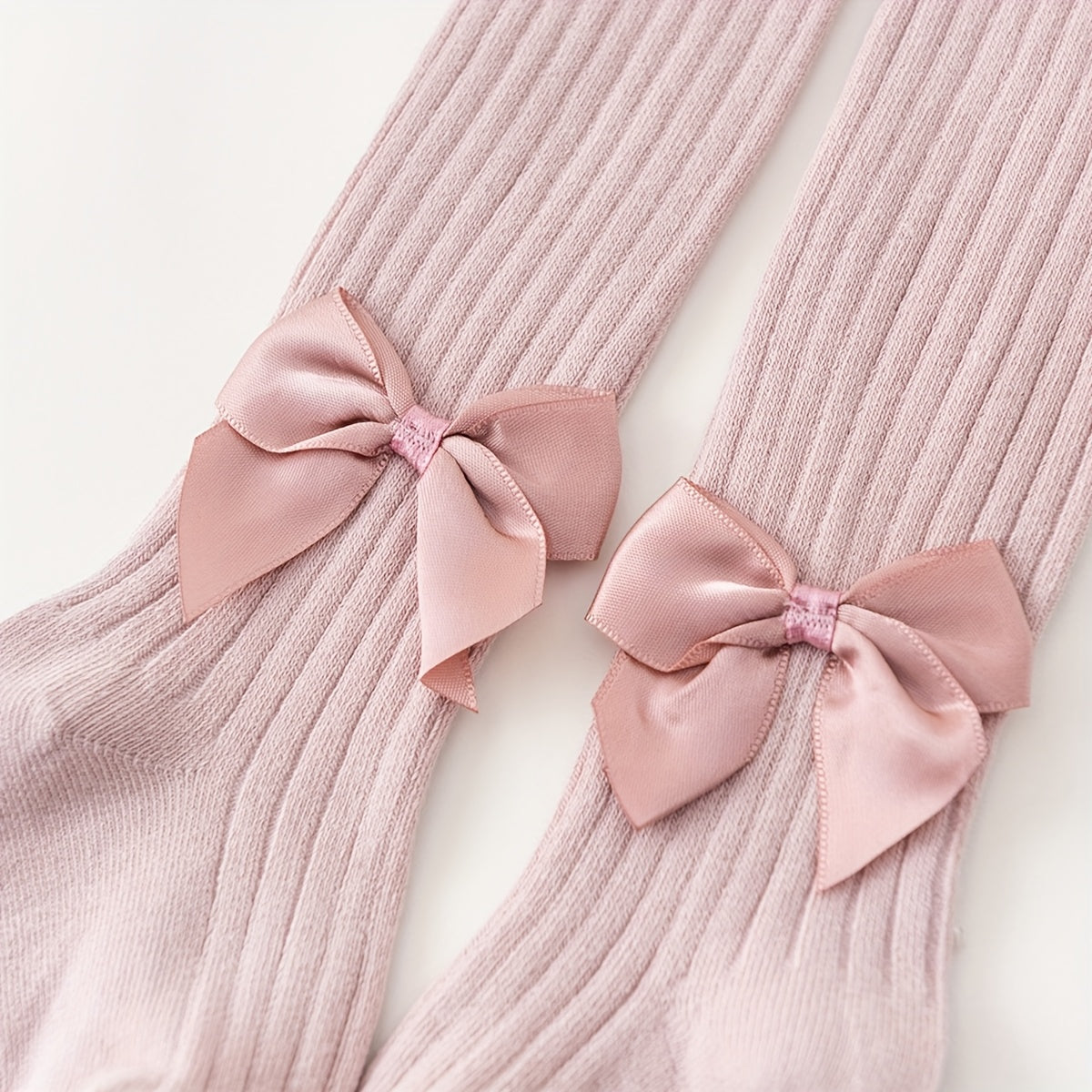 Adorable bow-knot girls' leggings socks in soft ribbed knit, perfect for dance and casual attire. Available in various colors.