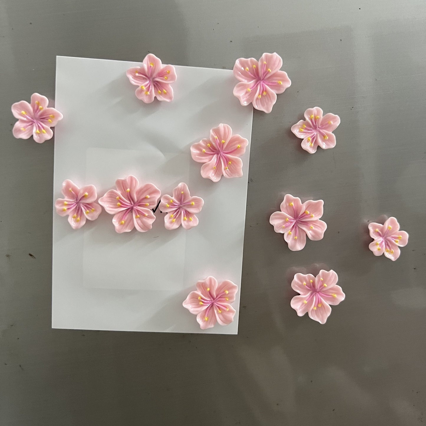 Add a touch of charm to your kitchen or office with this adorable 12-piece Pink Cherry Blossom Refrigerator Magnet Set. Made from durable ABS material, these cute and decorative magnets are perfect for use on office whiteboards, kitchen cabinets, and