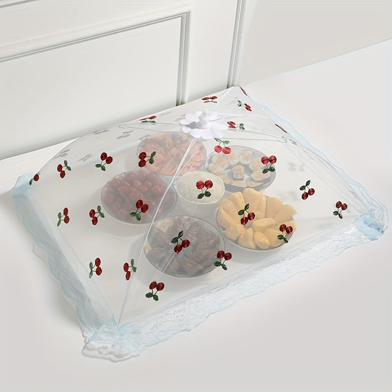 Foldable food cover with cherry design, lace trim and bow, protects against mosquitoes and dust, ideal for kitchen and dining.