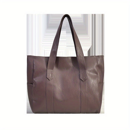 Chic black tote bag for women with foldable design, zip closure, multiple compartments, and polyester lining.