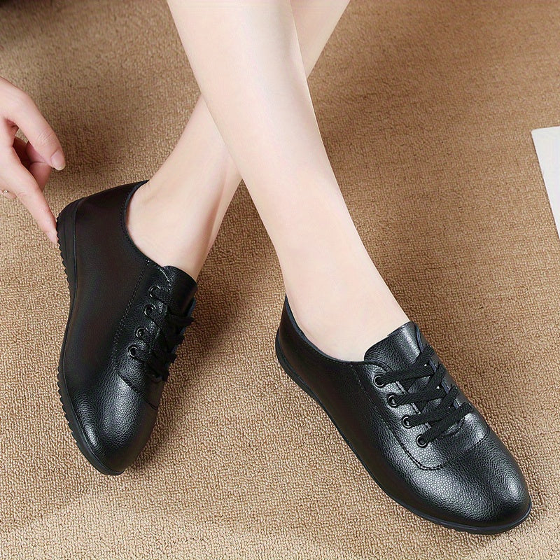 Women's lightweight solid color lace-up flat shoes for casual walking.