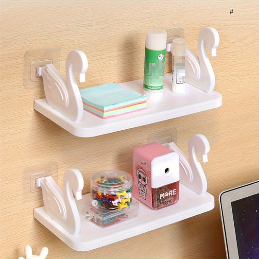 Wall-mounted swan-shaped bathroom shelves for storage and organization.