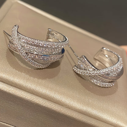 These stunning multi-layer earrings are adorned with intricate synthetic zirconia stones. The elegant C-shaped design makes them perfect for women to wear on their everyday outings, special occasions, or high-end events.