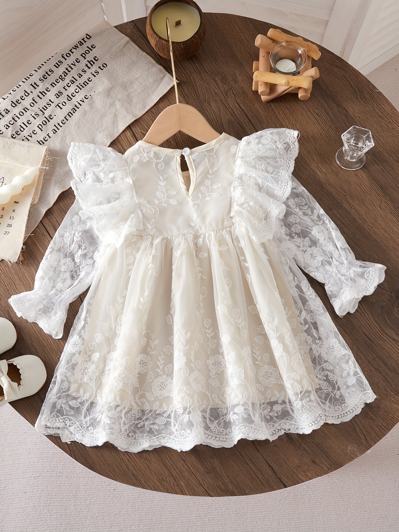 Infant girls' mesh dress with floral embroidery and chic style.