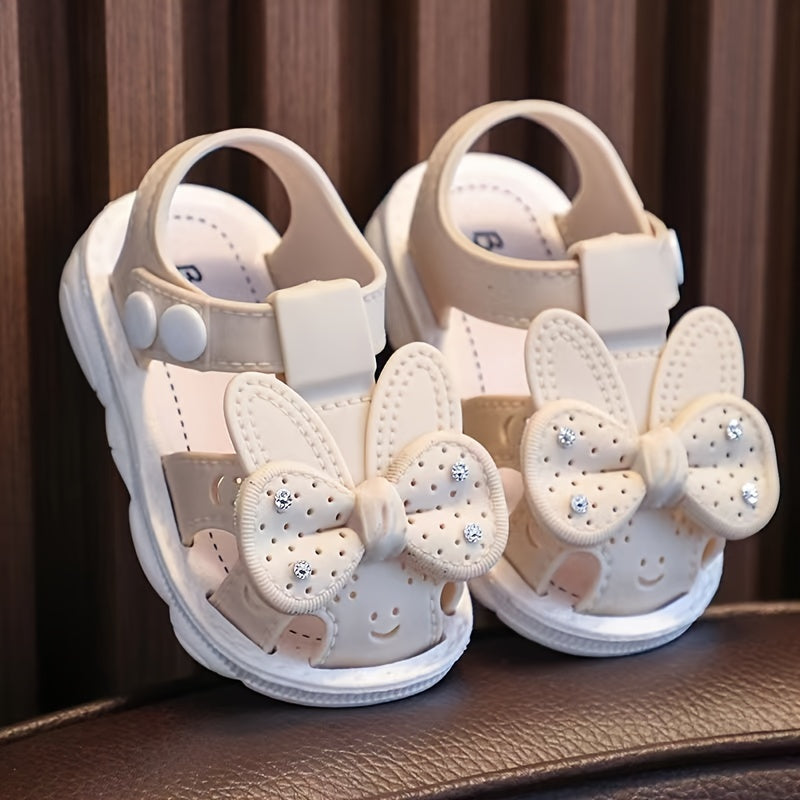 PVC low-top shoes for kids with cartoon and floral pattern, buckle closure, and soft sole.