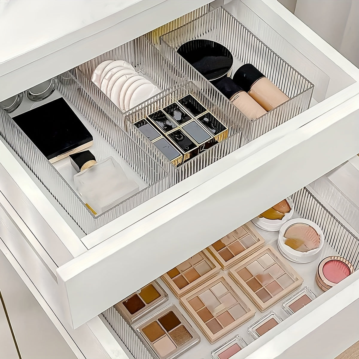 Clear plastic organizer set with customizable drawers for cosmetics and various storage needs, suitable for multiple spaces.