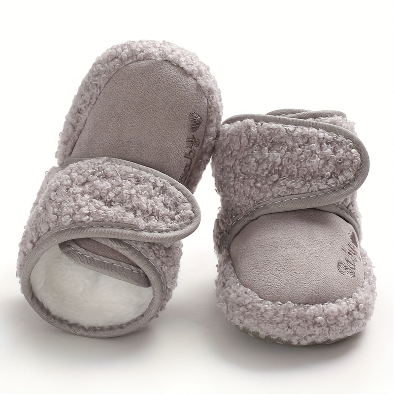 Cozy boots for baby boys and girls, featuring hook and loop fasteners for indoor and outdoor winter walks.