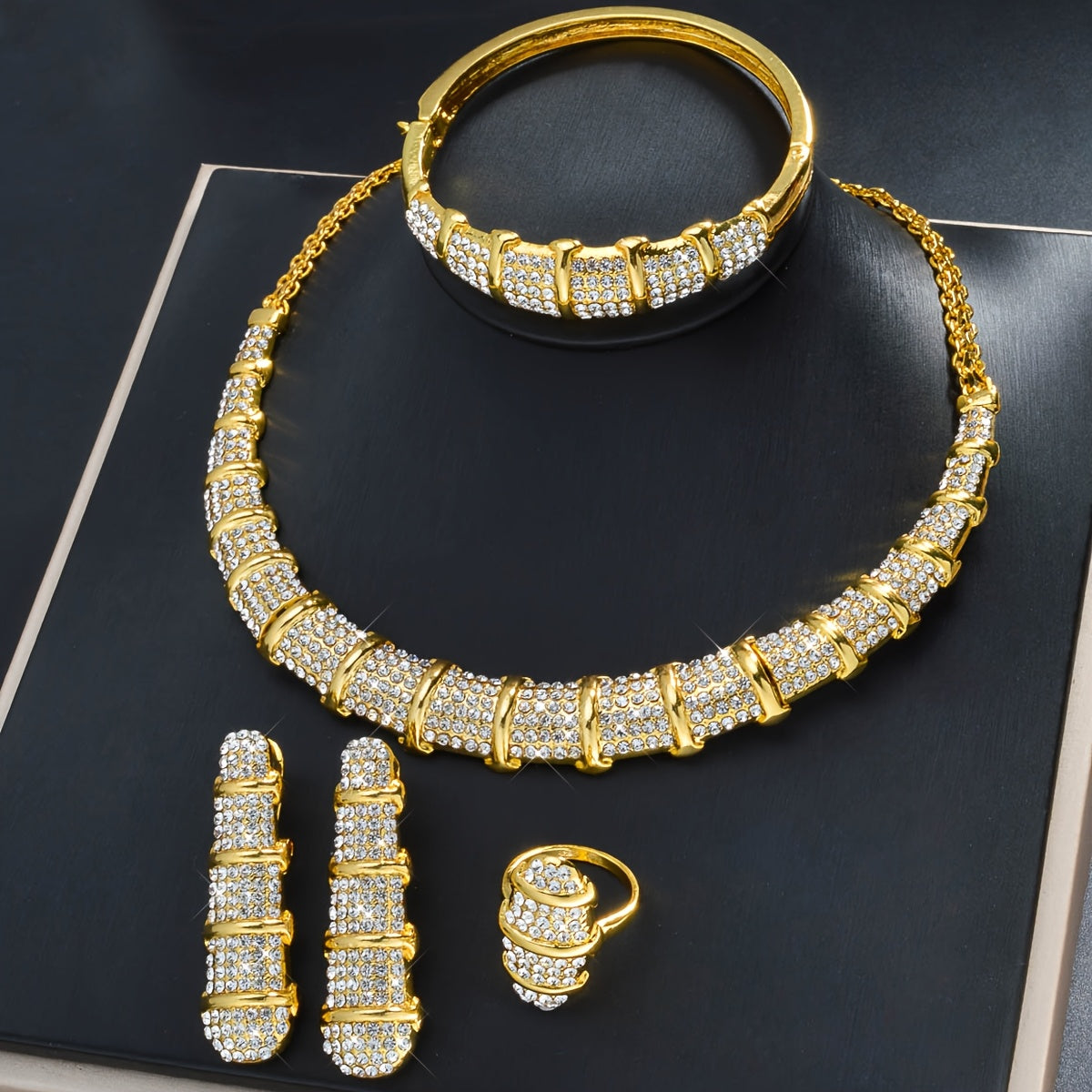 An elegant jewelry set designed for women, featuring a stunning bamboo-shaped necklace, bracelet, earrings, and ring. This four-piece set is perfect for sophisticated women attending weddings or as a luxurious holiday gift.