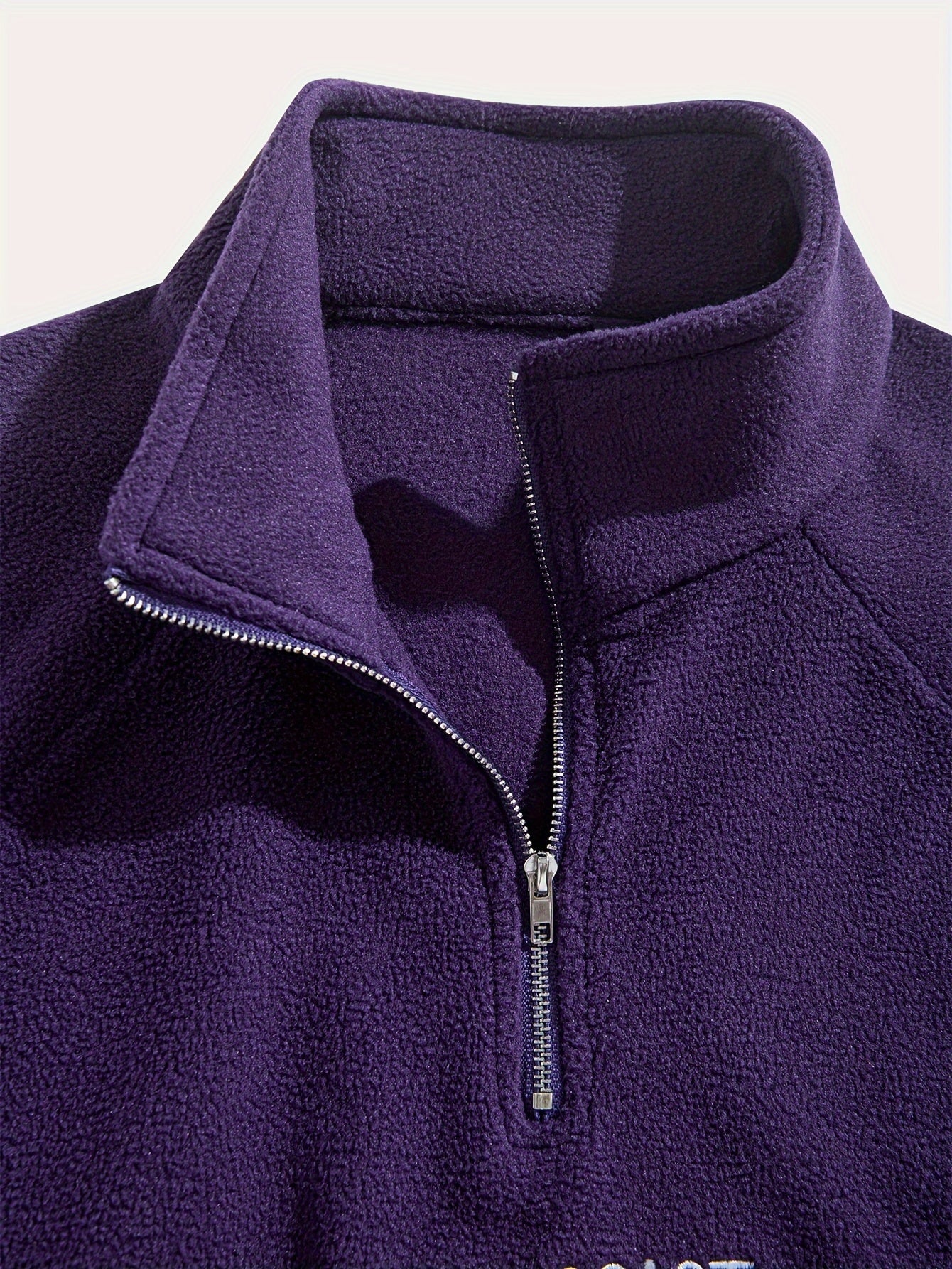 Men's embroidered fleece pullover with quarter-zip stand collar, casual long sleeves, and polyester blend fabric.