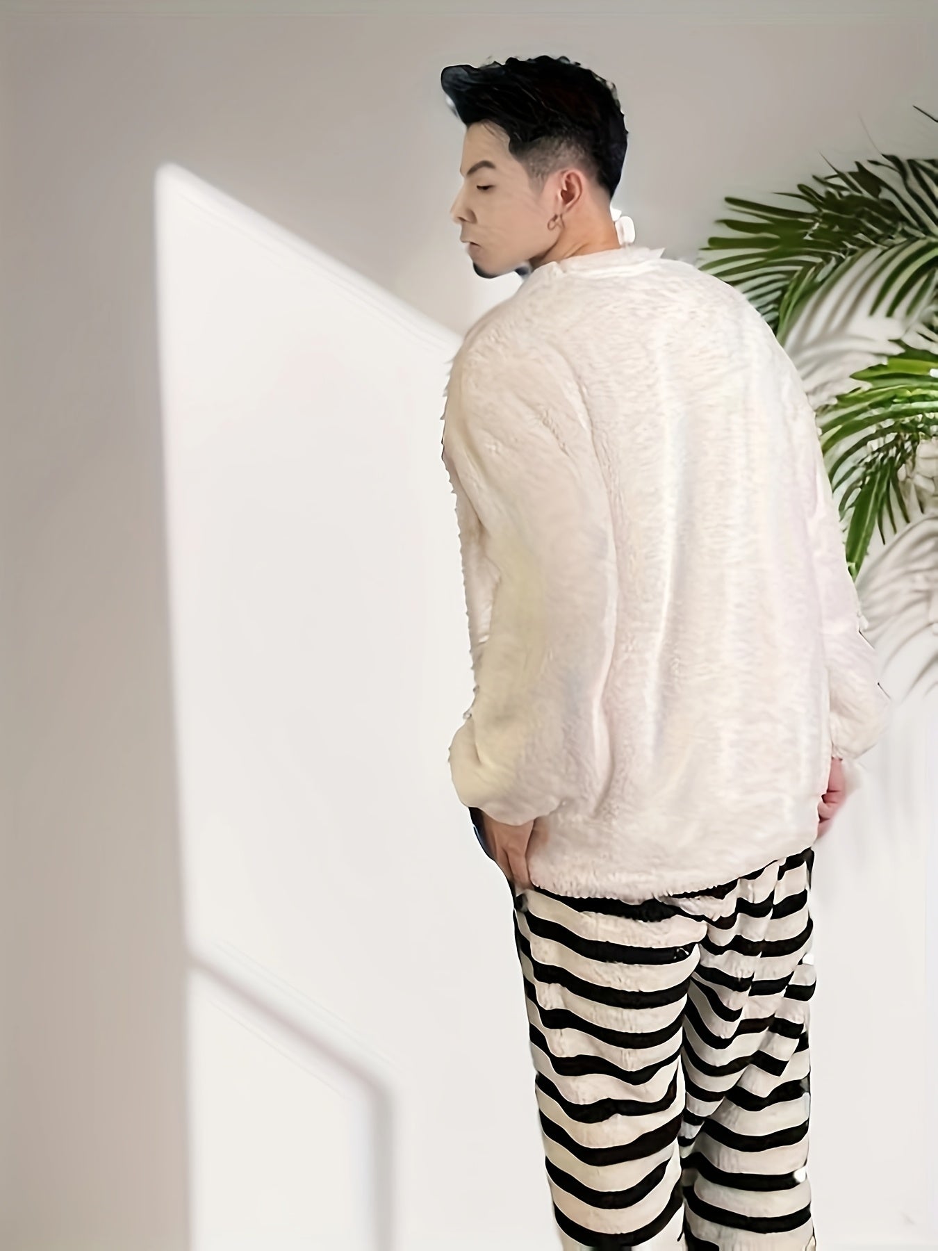 Men's casual style cartoon embroidered pajama set with long sleeve crew neck top and regular fit pants. Made with warm fleece fabric for fall/winter sleepwear.