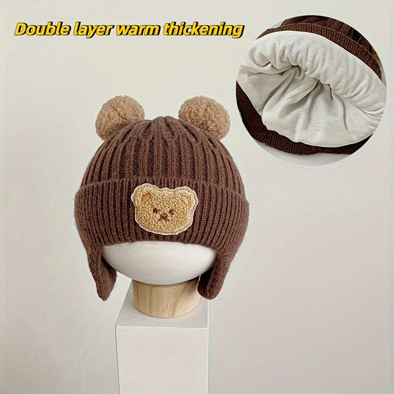 Soft polyester knit hat with cozy bear theme and ear warmers for young children, perfect winter gift for boys and girls aged 0-3 years. Comes in khaki, coffee, and ivory colors.