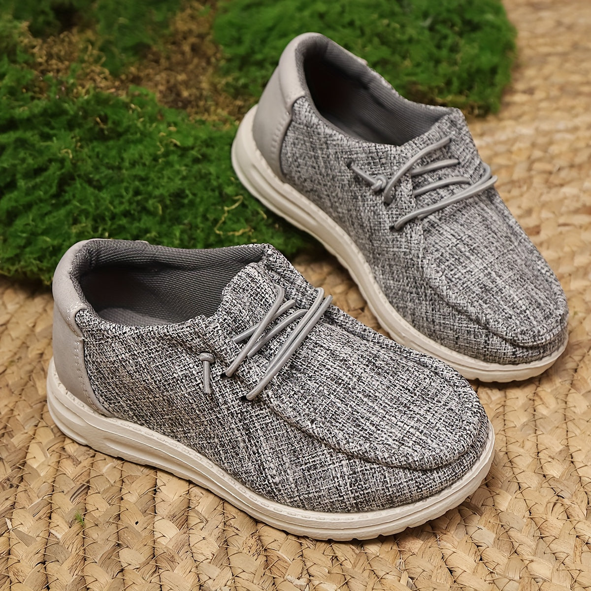 Breathable slip-on canvas sneakers with soft EVA sole and decorative stitching in gray fabric, ideal for all seasons and casual attire.