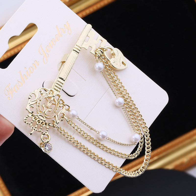 SKEDS Elegant Key-Shaped Brooch adorned with Rhinestones, Irregular Pearl, and Chain Tassel, a Stylish Korean Fashion Accessory for Both Women and Men